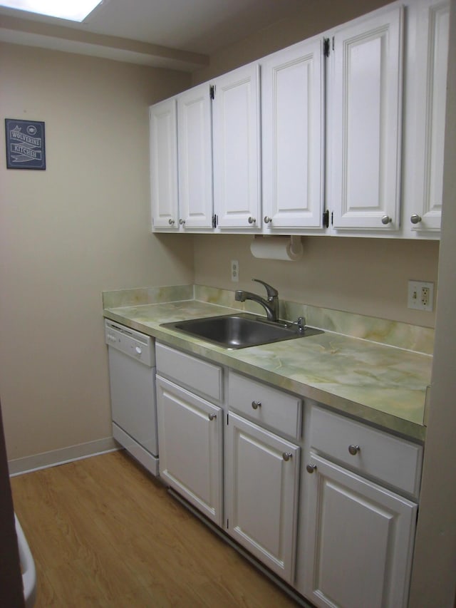 1531 Packard St Unit 2, Ann Arbor, MI 48104 - kitchen with white dishwasher, a sink, white cabinetry, and light countertops