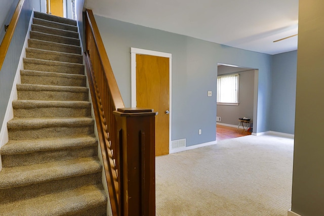 93 Illinois St, Battle Creek, MI 49014 - stairway featuring carpet flooring and baseboards