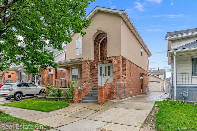 5410 Argyle St, Dearborn, MI 48126 - view of front facade featuring brick siding, stucco siding, and a gate