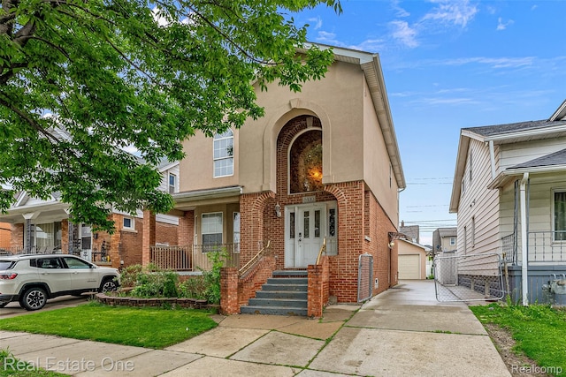 5410 Argyle St, Dearborn, MI 48126 - view of front of house with brick siding, an outbuilding, stucco siding, and a detached garage