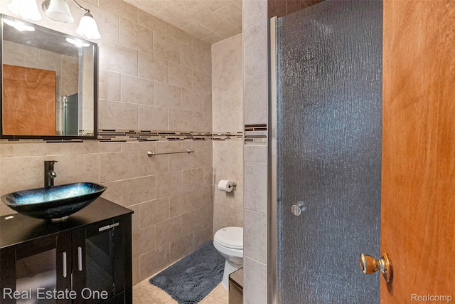 5410 Argyle St, Dearborn, MI 48126 - full bathroom featuring tile walls, toilet, vanity, tile patterned flooring, and an enclosed shower