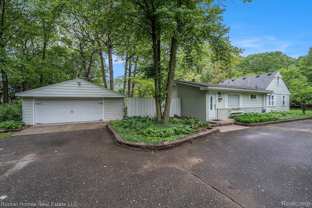 35825 Oakwood Ln, Westland, MI 48186 - view of front facade with a detached garage, an outbuilding, and brick siding