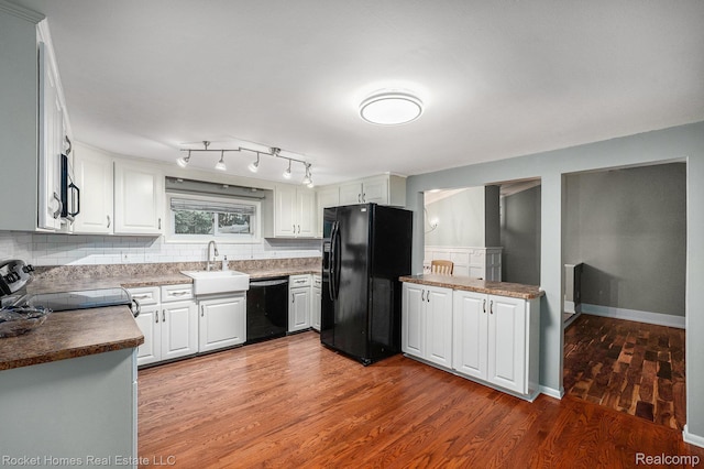 35825 Oakwood Ln, Westland, MI 48186 - kitchen with black appliances, a sink, light wood-style floors, tasteful backsplash, and white cabinetry