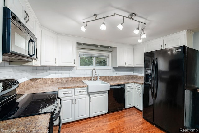 35825 Oakwood Ln, Westland, MI 48186 - kitchen featuring black appliances, a sink, backsplash, and white cabinetry