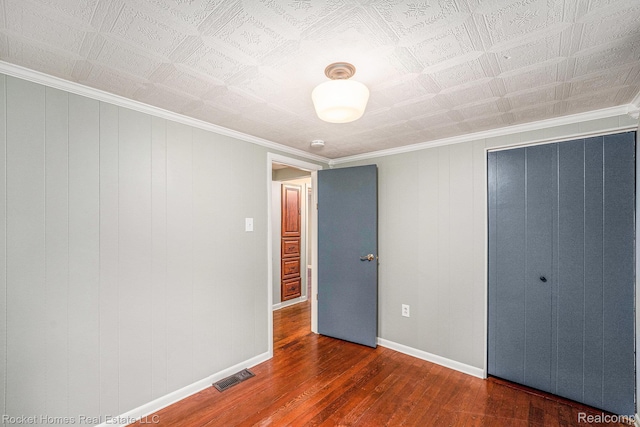 35825 Oakwood Ln, Westland, MI 48186 - unfurnished bedroom with hardwood / wood-style flooring, a closet, baseboards, and crown molding