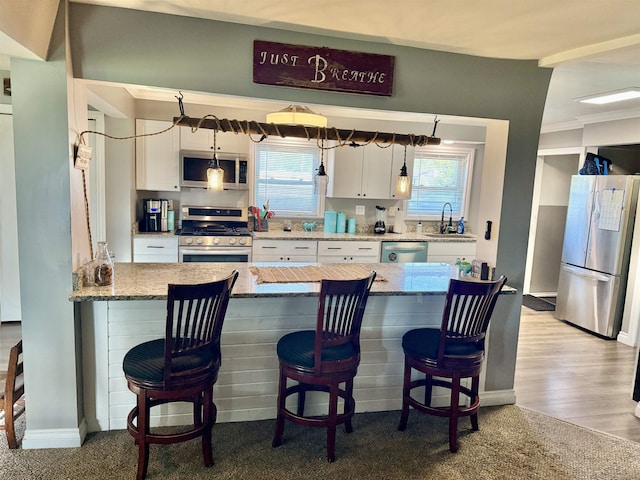 5547 Davison Rd, Davison, MI 48446 - kitchen featuring stainless steel appliances, a sink, white cabinetry, and healthy amount of natural light