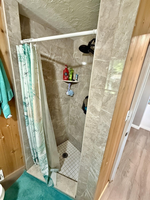 5547 Davison Rd, Davison, MI 48446 - bathroom featuring a stall shower and wood finished floors