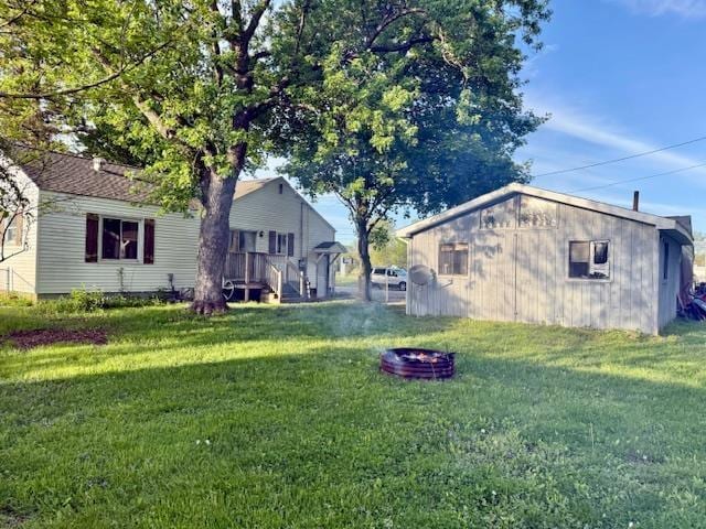 5547 Davison Rd, Davison, MI 48446 - view of green lawn featuring an outdoor fire pit