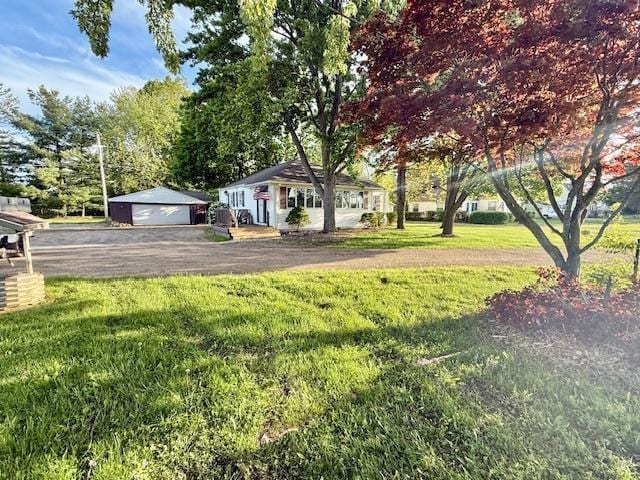 5547 Davison Rd, Davison, MI 48446 - view of green lawn with a detached garage and an outdoor structure