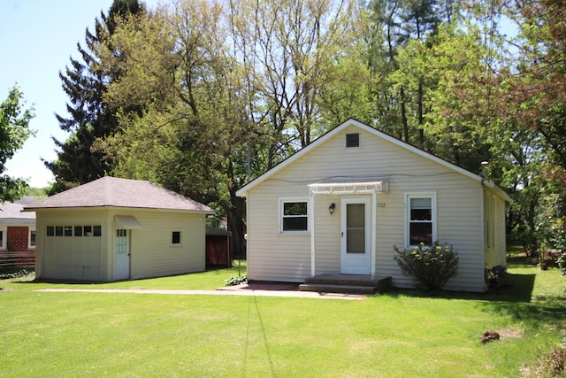 1772 E T Ave, Portage, MI 49002 - view of front of home featuring a detached garage, an outbuilding, and a front yard