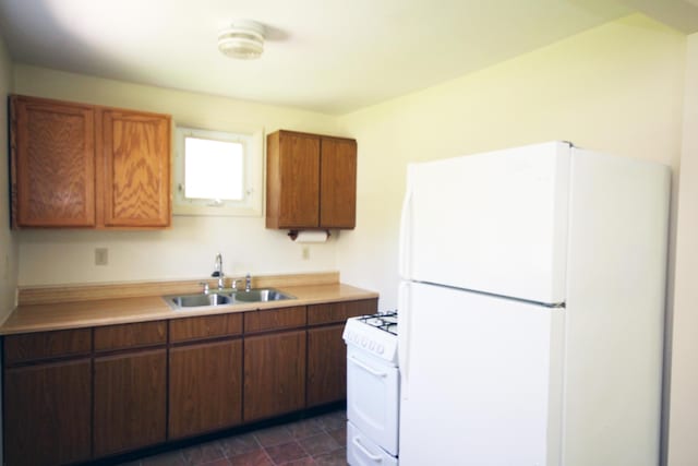 1772 E T Ave, Portage, MI 49002 - kitchen featuring white appliances, a sink, light countertops, and brown cabinetry
