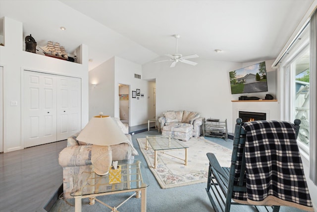 14814 Lark Dr, Camden, MI 49232 - living area with ceiling fan, a warm lit fireplace, high vaulted ceiling, and baseboards