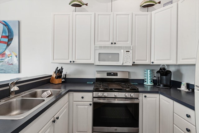 14814 Lark Dr, Camden, MI 49232 - kitchen with white microwave, stainless steel gas range, a sink, and white cabinetry