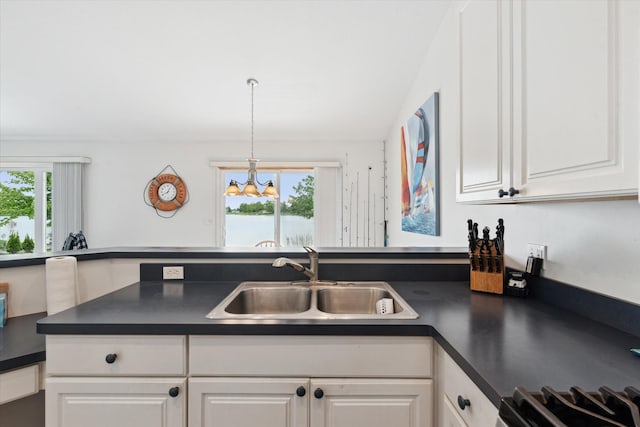 14814 Lark Dr, Camden, MI 49232 - kitchen featuring a sink, dark countertops, and white cabinets