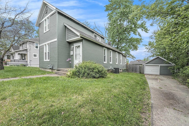 1535 Colorado Ave SE, Grand Rapids, MI 49507 - view of front of home with a detached garage, an outbuilding, cooling unit, concrete driveway, and a front lawn