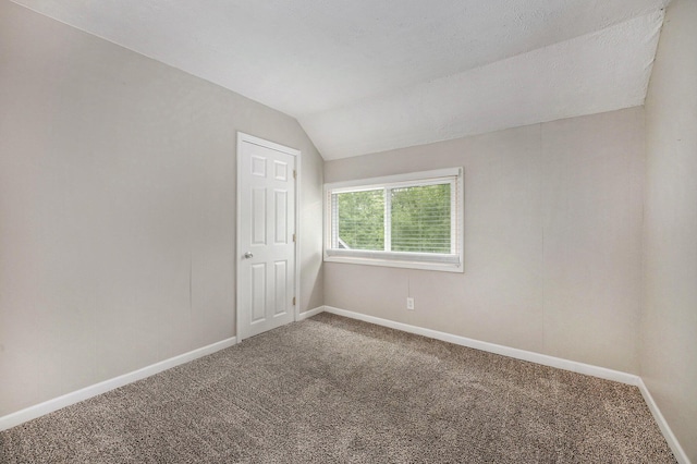 1535 Colorado Ave SE, Grand Rapids, MI 49507 - carpeted empty room with baseboards and vaulted ceiling