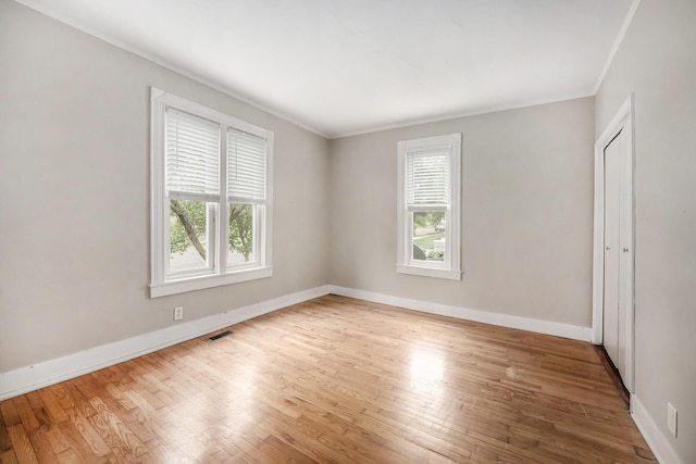1535 Colorado Ave SE, Grand Rapids, MI 49507 - empty room with plenty of natural light, ornamental molding, hardwood / wood-style flooring, and baseboards