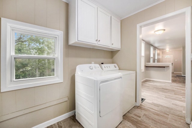 1535 Colorado Ave SE, Grand Rapids, MI 49507 - laundry room featuring washing machine and dryer, cabinet space, baseboards, and ornamental molding
