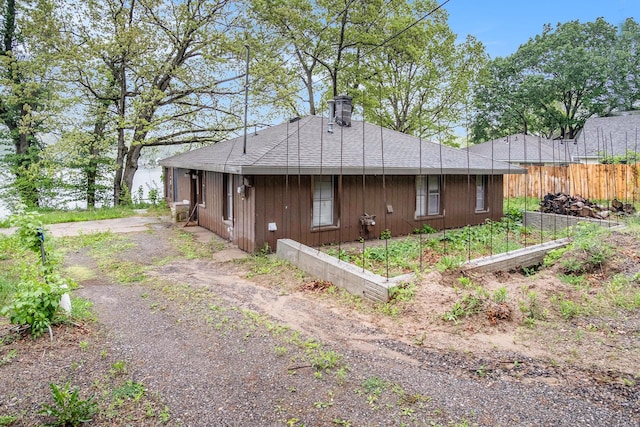 12948 Sandyside Dr, Gowen, MI 49326 - view of property exterior with a chimney and a vegetable garden
