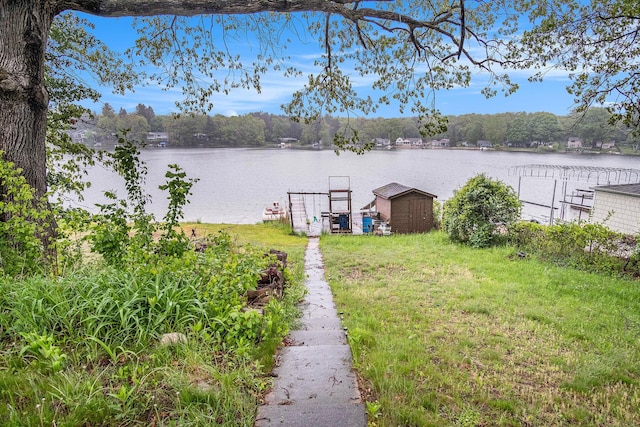 12948 Sandyside Dr, Gowen, MI 49326 - view of grassy yard with a water view, a dock, and a storage shed
