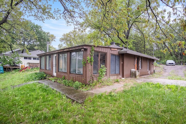 12948 Sandyside Dr, Gowen, MI 49326 - view of property exterior featuring a chimney and board and batten siding