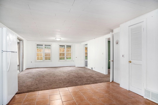 12948 Sandyside Dr, Gowen, MI 49326 - empty room with carpet and tile patterned floors