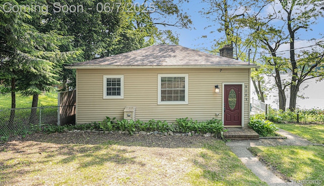 6288 Buckshore Dr, Whitmore Lake, MI 48189 - view of front of house with a chimney and roof with shingles