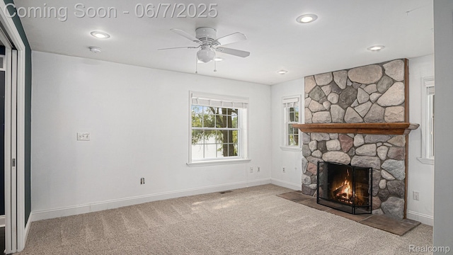 6288 Buckshore Dr, Whitmore Lake, MI 48189 - unfurnished living room featuring carpet, baseboards, a stone fireplace, a ceiling fan, and recessed lighting