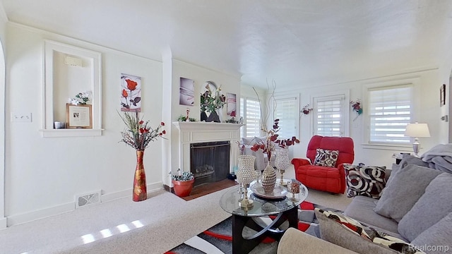 416 Marquette St, Flint, MI 48504 - living area featuring plenty of natural light, a fireplace with flush hearth, and carpet flooring
