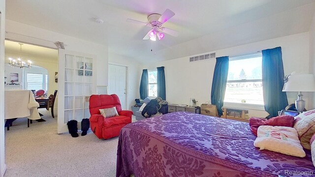 416 Marquette St, Flint, MI 48504 - carpeted bedroom featuring a chandelier, multiple windows, ceiling fan, and vaulted ceiling