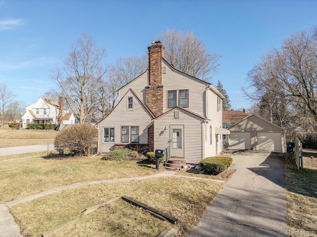 416 Marquette St, Flint, MI 48504 - view of front of property featuring a garage, an outdoor structure, a front yard, and a chimney