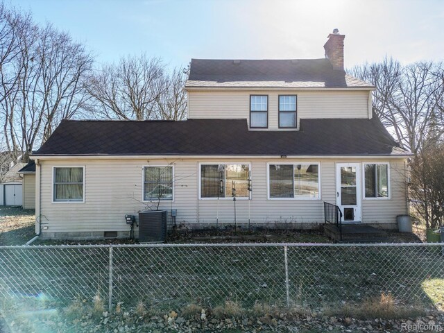 416 Marquette St, Flint, MI 48504 - view of front of property featuring central AC, a chimney, and a fenced backyard