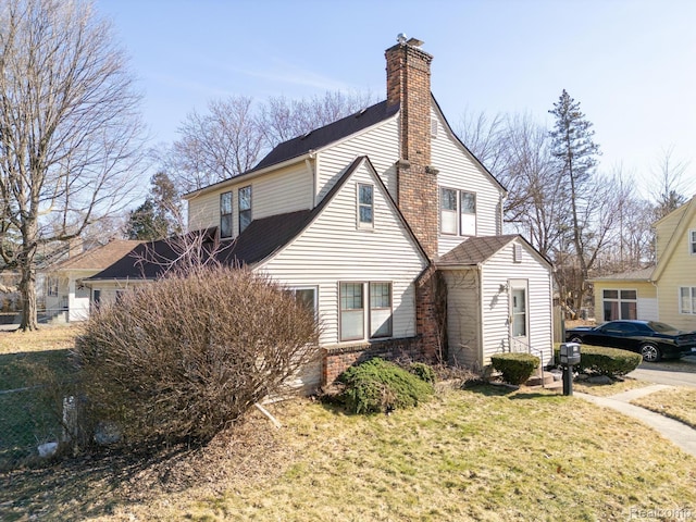 416 Marquette St, Flint, MI 48504 - view of side of home with a chimney and brick siding