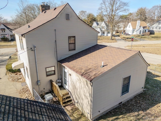 416 Marquette St, Flint, MI 48504 - view of side of home with roof with shingles, a chimney, and a residential view