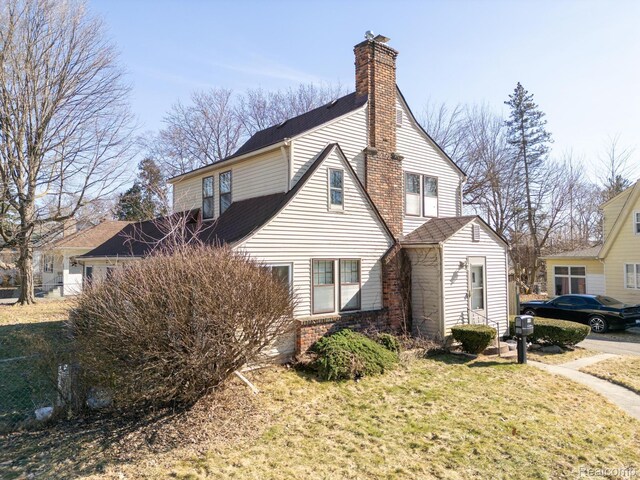 416 Marquette St, Flint, MI 48504 - view of side of home with a chimney and brick siding