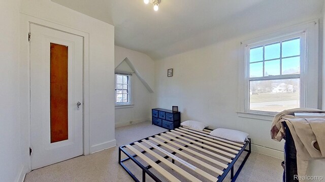 416 Marquette St, Flint, MI 48504 - bedroom with carpet floors, vaulted ceiling, and baseboards