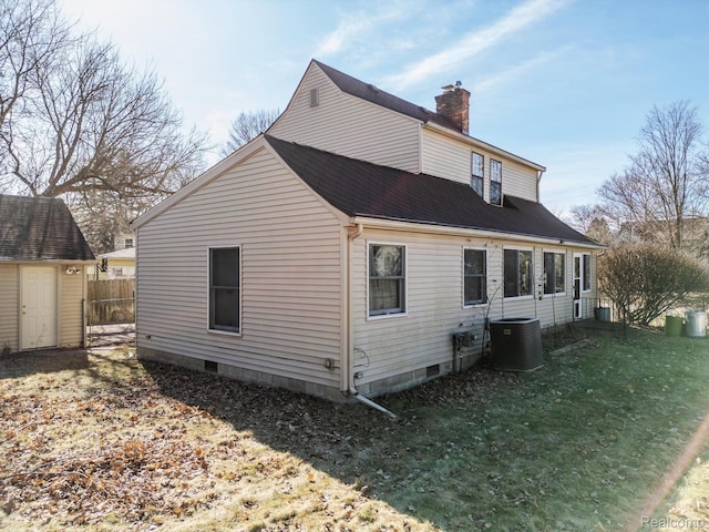 416 Marquette St, Flint, MI 48504 - view of side of property featuring a chimney, central air condition unit, and roof with shingles