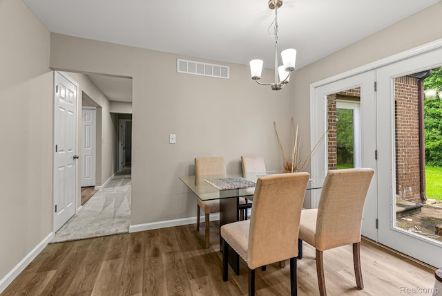 4766 Quarton Rd, Bloomfield, MI 48302 - dining space featuring wood finished floors, a chandelier, and baseboards