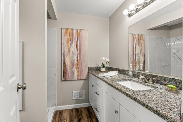 4766 Quarton Rd, Bloomfield, MI 48302 - full bathroom with vanity, a shower, baseboards, and wood finished floors