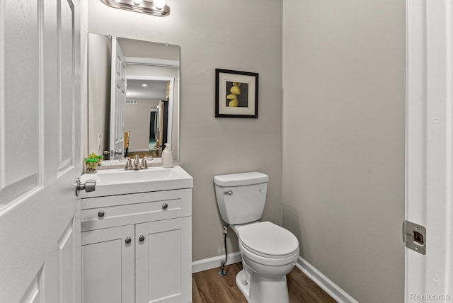 4766 Quarton Rd, Bloomfield, MI 48302 - bathroom with wood finished floors, vanity, toilet, and baseboards