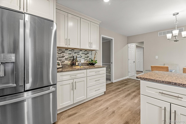 4766 Quarton Rd, Bloomfield, MI 48302 - kitchen with stainless steel fridge with ice dispenser, a chandelier, backsplash, light wood-type flooring, and dark stone counters