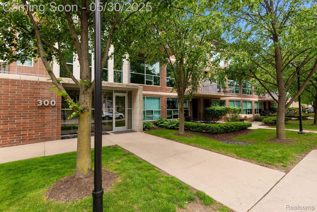 300 Hamilton St Unit 203, Plymouth, MI 48170 - view of front facade featuring a front lawn and brick siding