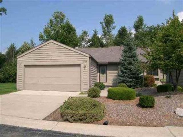 2448 Valley Oaks Cir, Flint, MI 48532 - view of front facade with driveway and a garage