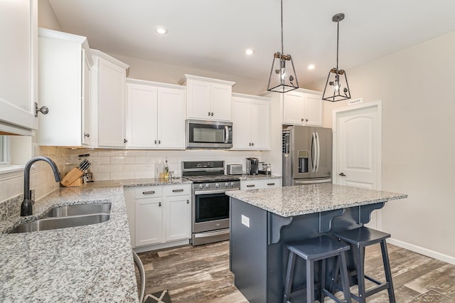7302 Geraldine Cir, Swartz Creek, MI 48473 - kitchen featuring stainless steel appliances, a sink, dark wood-style floors, white cabinets, and recessed lighting