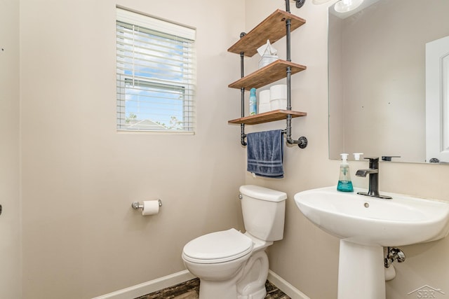 7302 Geraldine Cir, Swartz Creek, MI 48473 - half bath with baseboards, toilet, and wood finished floors