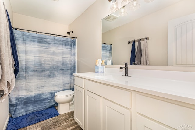 7302 Geraldine Cir, Swartz Creek, MI 48473 - full bath with toilet, vanity, wood finished floors, and a shower with curtain