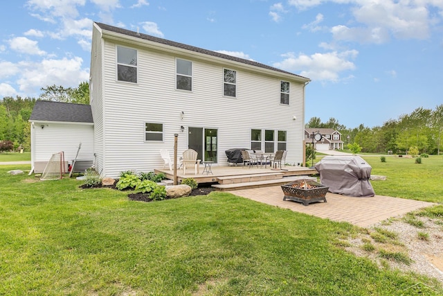 7302 Geraldine Cir, Swartz Creek, MI 48473 - rear view of property featuring a fire pit, a wooden deck, a lawn, and a patio area