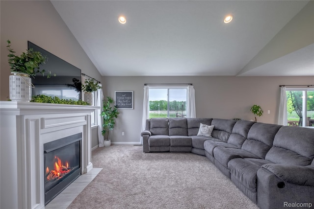 13109 River Rock Pass, Linden, MI 48451 - living room featuring lofted ceiling, a fireplace with flush hearth, baseboards, light colored carpet, and recessed lighting