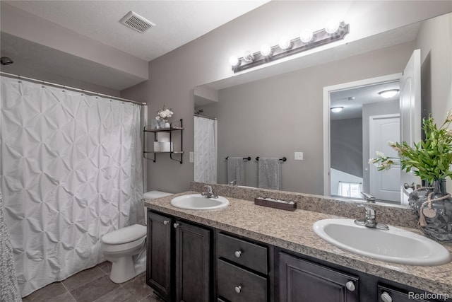 13109 River Rock Pass, Linden, MI 48451 - bathroom with double vanity, toilet, a shower with shower curtain, and tile patterned flooring