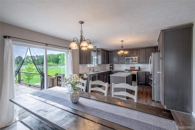 13109 River Rock Pass, Linden, MI 48451 - dining room with a chandelier, wood finished floors, and a textured ceiling